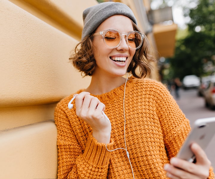Smiling woman studying online courses outdoors